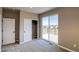 Comfortable bedroom with carpet, large windows and sliding glass doors leading to an outdoor deck with scenic views at 8633 Middle Fork St, Littleton, CO 80125
