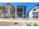 Contemporary three-story home with stone accents, balconies, and a well-maintained front yard at 8633 Middle Fork St, Littleton, CO 80125