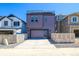 Modern home with a sleek design, a glass panel garage door, and a rooftop terrace at 8633 Middle Fork St, Littleton, CO 80125
