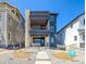 Modern three-story home boasts stone accents, a roof deck, and multiple balconies for outdoor enjoyment at 8633 Middle Fork St, Littleton, CO 80125
