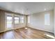 Inviting living room with wood-look flooring, ample natural light, and neutral walls at 8633 Middle Fork St, Littleton, CO 80125