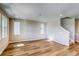 Bright, open living room with wood-look floors, neutral paint, and large windows for ample natural light at 8633 Middle Fork St, Littleton, CO 80125