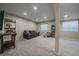 Spacious finished basement with a cozy living area and an electric fireplace for relaxing evenings at 20898 E Hamilton Ave, Aurora, CO 80013