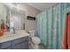 Cozy bathroom featuring a vanity, toilet, and seashell-themed shower curtain at 20898 E Hamilton Ave, Aurora, CO 80013