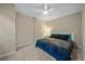 Comfortable bedroom with a ceiling fan, plush carpeting, and modern neutral decor at 20898 E Hamilton Ave, Aurora, CO 80013