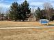 Community park with mature trees, playground equipment, and a sign for Blue Grama Grass Park at 20898 E Hamilton Ave, Aurora, CO 80013