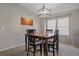 Bright dining area featuring a stylish light fixture and large windows at 20898 E Hamilton Ave, Aurora, CO 80013