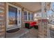 Inviting front porch with comfortable seating and brick accents at 20898 E Hamilton Ave, Aurora, CO 80013