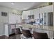 Bright kitchen featuring granite countertops, a breakfast bar, and stainless steel appliances at 20898 E Hamilton Ave, Aurora, CO 80013