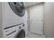 Functional laundry area with a stacked washer and dryer and ample storage at 20898 E Hamilton Ave, Aurora, CO 80013
