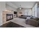 Cozy living room with a fireplace, ceiling fan, and comfortable seating area at 20898 E Hamilton Ave, Aurora, CO 80013