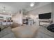 Open-concept living space featuring a modern fireplace, seamless flow to kitchen, and comfortable seating at 20898 E Hamilton Ave, Aurora, CO 80013