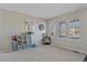 Bright play room with multiple windows, clock and white mirror at 20898 E Hamilton Ave, Aurora, CO 80013