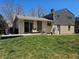 Back exterior view of the house, patio and a large grassy yard at 4609 S Kalispell Way, Aurora, CO 80015