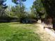 Large grassy backyard, featuring a seating area with three Adirondack chairs at 4609 S Kalispell Way, Aurora, CO 80015