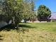 Lush backyard featuring a grassy lawn, trees, and a wooden fence providing privacy at 4609 S Kalispell Way, Aurora, CO 80015