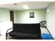 Finished basement area with a futon sofa and decorative artwork on the light green colored walls at 4609 S Kalispell Way, Aurora, CO 80015