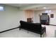 Inviting basement with a brick fireplace, entertainment center, and comfortable seating at 4609 S Kalispell Way, Aurora, CO 80015