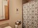 Bathroom featuring patterned shower curtain, wall art, and vanity at 4609 S Kalispell Way, Aurora, CO 80015