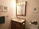 Bathroom vanity featuring countertop, sink, lighting, and mirror at 4609 S Kalispell Way, Aurora, CO 80015