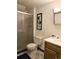 Bathroom featuring a toilet, vanity with sink, shower with glass door, and decor at 4609 S Kalispell Way, Aurora, CO 80015