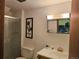 Bathroom with a vanity, sink, toilet, shower with glass door and decorative art at 4609 S Kalispell Way, Aurora, CO 80015
