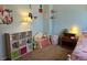 Bedroom featuring shelving units, soft furnishings, and hardwood nightstand at 4609 S Kalispell Way, Aurora, CO 80015