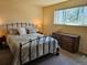 Bedroom featuring wrought iron bed frame and natural light at 4609 S Kalispell Way, Aurora, CO 80015