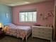 Bright bedroom with blue and pink walls, dresser, and window at 4609 S Kalispell Way, Aurora, CO 80015