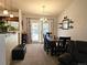 Charming dining area with a dark wood table, French doors to the exterior, and neutral walls for a warm atmosphere at 4609 S Kalispell Way, Aurora, CO 80015