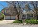 Charming two-story home with attached two-car garage, brick and siding and a well-maintained lawn at 4609 S Kalispell Way, Aurora, CO 80015