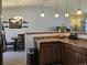 Kitchen leading to dining room with modern pendant lighting at 4609 S Kalispell Way, Aurora, CO 80015