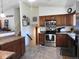 Open kitchen featuring stainless steel appliances and a view of the basement stairs at 4609 S Kalispell Way, Aurora, CO 80015