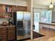 Traditional kitchen with stainless steel refrigerator and access to backyard at 4609 S Kalispell Way, Aurora, CO 80015