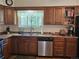 The kitchen is equipped with wood cabinets and stainless steel dishwasher, perfect for easy cleanup at 4609 S Kalispell Way, Aurora, CO 80015