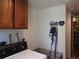 Practical laundry space with overhead cabinetry, adjacent pantry, and a convenient pet area at 4609 S Kalispell Way, Aurora, CO 80015
