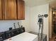 Laundry room with upper cabinets, washer, and dryer, and accessories on wall at 4609 S Kalispell Way, Aurora, CO 80015