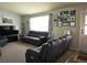 Living room featuring comfortable seating, a large window, and personalized wall decor creating a warm, inviting atmosphere at 4609 S Kalispell Way, Aurora, CO 80015