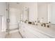 Modern bathroom featuring double sinks, marble countertops, and a glass-enclosed shower at 10880 E Hinsdale Cir, Centennial, CO 80112