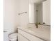 Modern bathroom featuring white marble countertops, brushed gold fixtures, and toilet at 10880 E Hinsdale Cir, Centennial, CO 80112