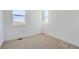 This bedroom features neutral carpet, bright windows, and white walls at 10880 E Hinsdale Cir, Centennial, CO 80112