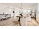 Bright and airy dining area featuring a round table, modern chandelier and staircase access at 10880 E Hinsdale Cir, Centennial, CO 80112