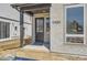 Charming front door with brick surround and modern address numbers at 10880 E Hinsdale Cir, Centennial, CO 80112