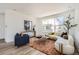 Bright living room featuring modern decor, a large window, and stylish furniture at 10880 E Hinsdale Cir, Centennial, CO 80112