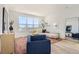 Open-concept living room with large windows, stylish decor, and modern furnishings at 10880 E Hinsdale Cir, Centennial, CO 80112
