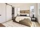 Cozy primary bedroom with a large bed, sliding door, natural light, and a plush rug at 10880 E Hinsdale Cir, Centennial, CO 80112
