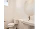 Stylish powder room featuring a pedestal sink, round mirror, and modern fixtures at 10880 E Hinsdale Cir, Centennial, CO 80112