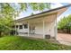 Spacious covered back patio with a concrete floor and access to the backyard at 7563 Lamar Ct, Arvada, CO 80003