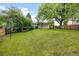Lush backyard with a covered porch perfect for relaxing at 7563 Lamar Ct, Arvada, CO 80003