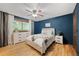Serene bedroom with hardwood floors, a white dresser, and a cozy queen bed with soft bedding at 7563 Lamar Ct, Arvada, CO 80003